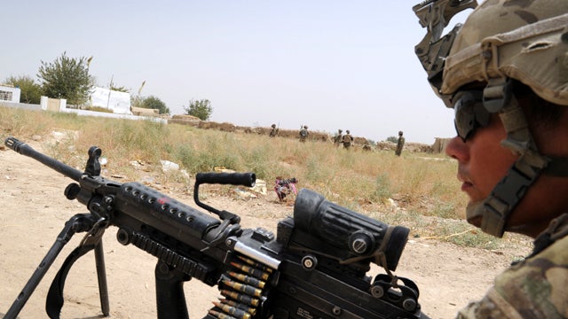 U.S. troops and Afghan National Army soldiers patrol near the Mullah Omar mosque, background left, in Sangsar, Afghanistan, in the Taliban stronghold of Kandahar Aug. 10, 2011. U.S. troops under Afghanistan's International Security Assistance Force are tr 