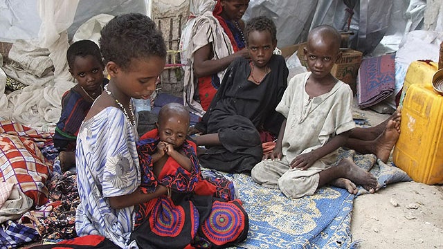 A Somali family from southern Somalia sit in their makeshift shelter in a refugee camp in Mogadishu, Somalia, Aug 15, 2011.  