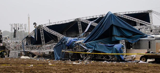 Indiana State Police and authorities survey the collapsed rigging and Sugarland stage on the infield at the Indiana State Fair in Indianapolis, Sunday, Aug. 14, 2011 