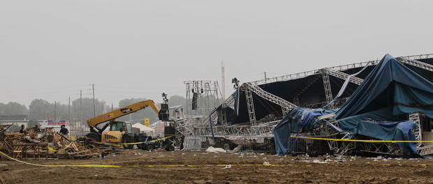 Indiana State Police and authorities survey the collapsed rigging and Sugarland stage on the infield at the Indiana State Fair in Indianapolis, Sunday, Aug. 14, 2011. 