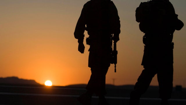 Israeli soldiers secure the area near a road block formed by security forces on roads leading to the sites of several attacks in the Arava desert in southern Israel Aug. 18, 2011. Assailants armed with heavy weapons, guns and explosives crossed into south 