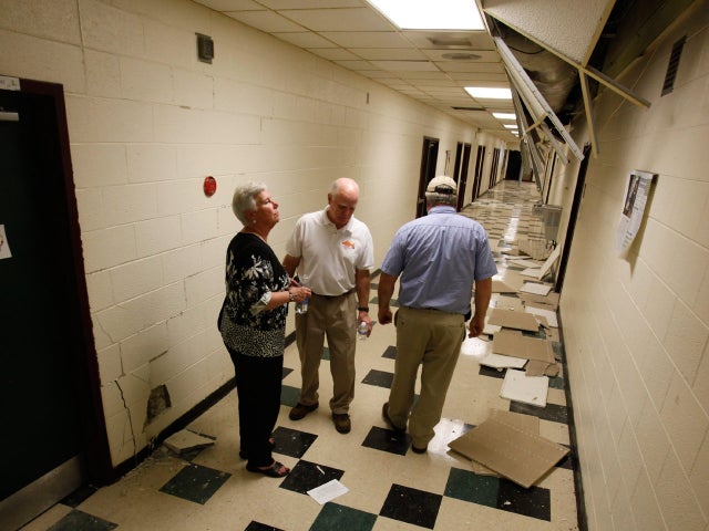 School officials survey the damage to Louis County High school after the 5.8 magnitude earthquake in Mineral, Va.  Aug. 23, 2011.  