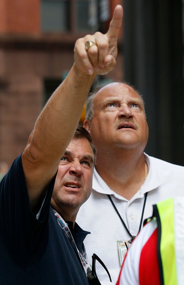 People look up at a downtown building after an earthquake was felt in Baltimore, Tuesday, Aug. 23, 2011.  