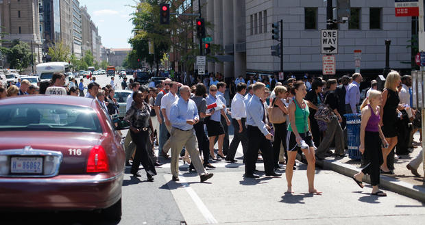 Pedestrians cross an intersection of downtown Washington, Tuesday, Aug. 23, 2011, after office buildings where evacuated following a reported 5.9 earthquake was felt in Washington.  