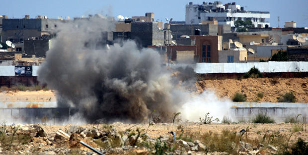 An explosion is seen near Muammar Qaddafi's main compound in the Bab al-Aziziya district in Tripoli, Libya, Aug. 23, 2011. Fresh fighting erupted in Tripoli hours after Qaddafi's son turned up free to thwart Libyan rebel claims that he had been captured,  