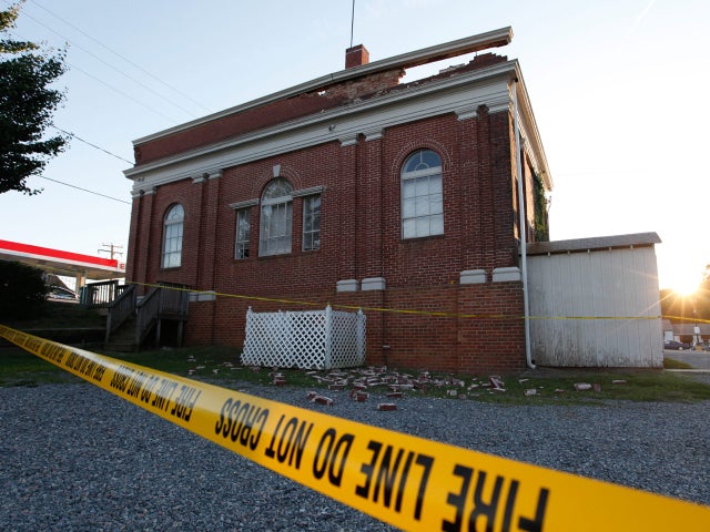 The sun sets behind a quake damaged building in Mineral, Va., a small town close to the epicenter,  Aug. 23, 2011.  