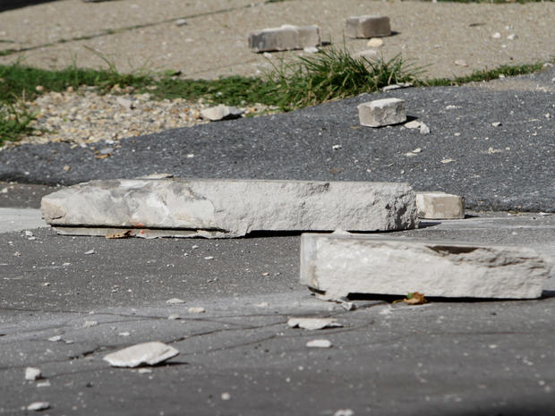 Large pieces of concrete lay in the street in front of the Embassy of Ecuador after the building was damaged in an earthquake. 