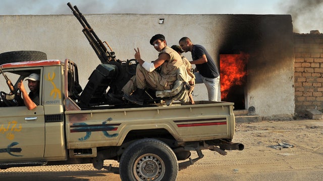 Libyan rebels celebrate after defeating loyalist troops in Al-Jamil, western Libya 