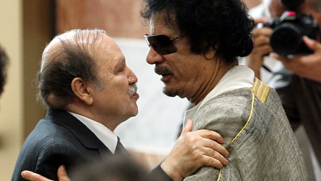 Libyan leader Muammar Qaddafi, right, embraces Algerian President Abdelaziz Bouteflika during the opening session of the Arab League Extraordinary Summit in the Libyan coastal city of Sirte. 