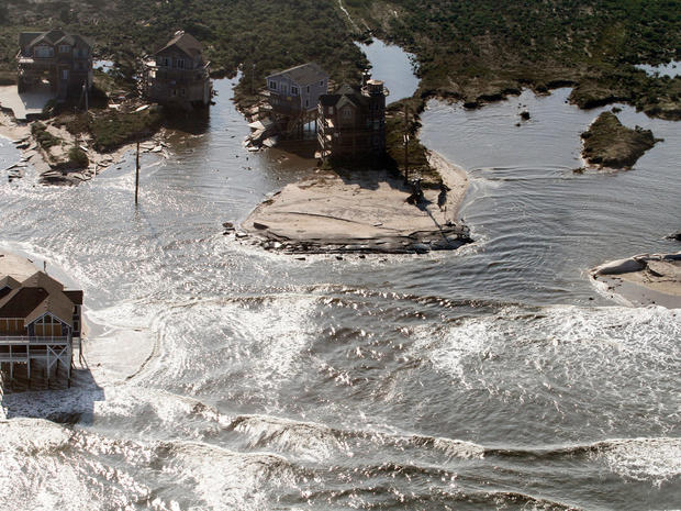 A flooded road is seen in Hatteras Island, N.C., Sunday, Aug. 28, 2011, after Hurricane Irene swept through the area Saturday cutting the roadway in five locations. 