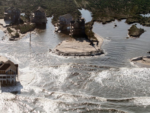 A flooded road is seen in Hatteras Island, N.C., Sunday, Aug. 28, 2011, after Hurricane Irene swept through the area Saturday cutting the roadway in five locations. 