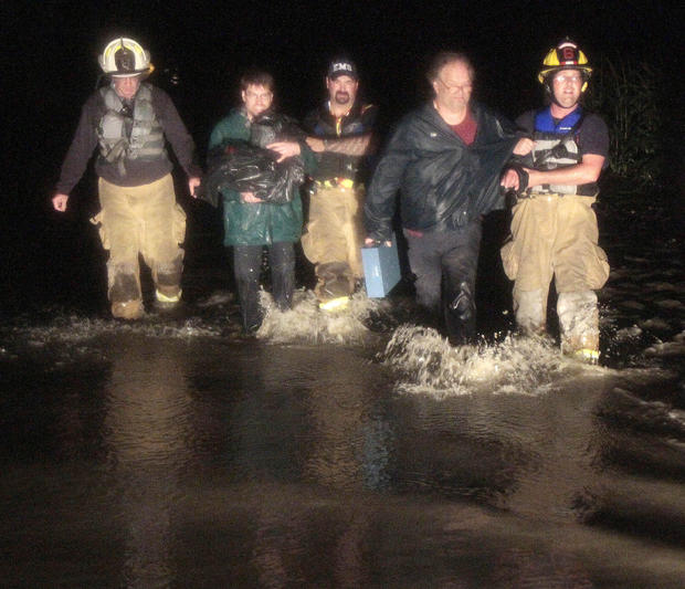 Rescue personnel bring stranded residents to shore on Sunday, Aug. 28, 2011, in Montpelier, Vt.  