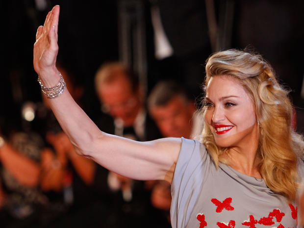 Singer Madonna waves to her fans as she arrives for the premiere of her movie "W.E." at the Venice Film Festival on Sept. 1, 2011. 