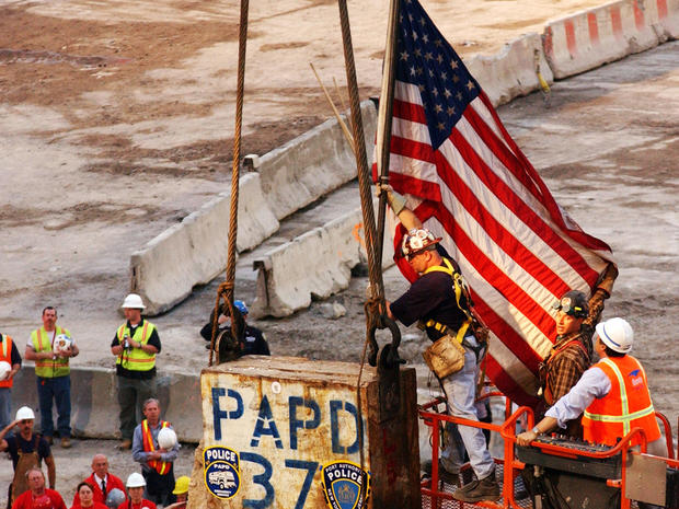 An American flag that stood on top of the last support beam from the south tower of the former World Trade Center is removed moments before the beam is dismantled and loaded onto a flatbed truck during a ceremony at ground zero May 28, 2002, in New York.  