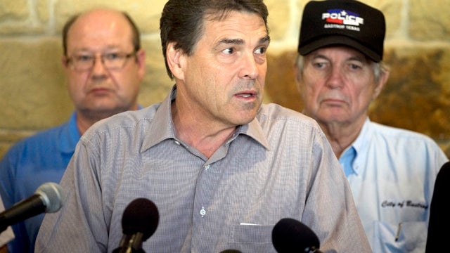 Texas Gov. Rick Perry holds a news conference to discuss wildfires in Central Texas Sept. 5, 2011, in Bastrop, Texas. A roaring wildfire raced unchecked Monday through rain-starved farm and ranchland in Texas, destroying nearly 500 homes during a rapid ad 