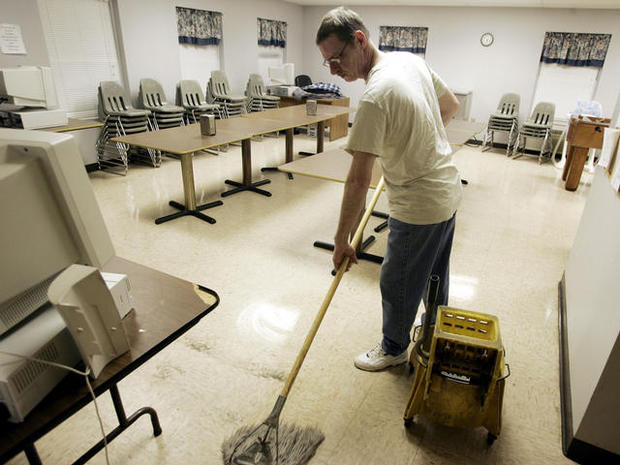 Homeless veteran mops the floor of the dining room at Scott Place shelter, Fairmont, West Virginia 