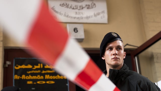German police officers stand guard outside a Berlin Islamic center 