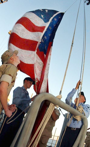 Lance Corporal Andrew Avant of Bellierica, Mass.; Intelligence Specialist 3rd Class John Gray of Columbia, Mo.; Sergeant Gary Bass from West Palm Beach, Fla.; and Disbursing Clerk 2nd Class Thomas Jack from Goose Creek, S.C., prepare Dec. 11, 2001, aboard 