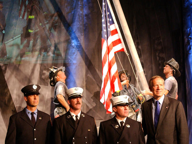 New York Republican Gov. George Pataki stands with, from left to right, firefighter Billy Eisengrein, Lt. Dan McWilliams and Lt. George Johnson at Madame Tussauds wax museum Sept. 3, 2002, in New York City in front of a wax replica of the photograph by Th 