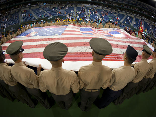 Representatives from the Wounded Warrior Detachment of the Twentynine Palms Marine Corps Air Ground Combat Center hold the National 9/11 Flag during the Salute to Heroes ceremony during the BNP Paribas Open at the Indian Wells Tennis Garden March 11, 2011 