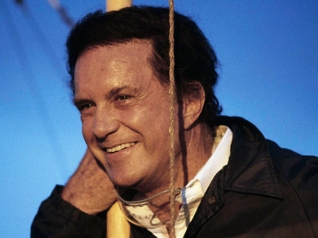 Cliff Robertson smiles after he test-piloted a replica of an airplane challenging the Wright brother's status as the first to fly in a tethered test flight 