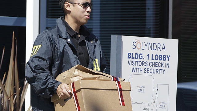 FBI agent carry a box of evidence from Solyndra headquarters in Fremont, Calif., Sept. 8, 2011.  