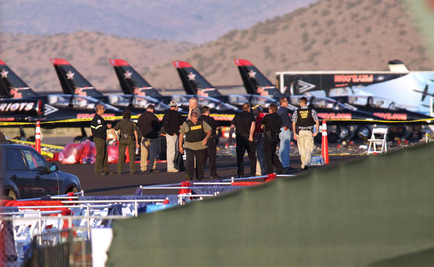 People gather at the scene where a World War II fighter plane crashed into the stands at the Reno Air Races Friday, Sept. 16, 2011, in Stead, Nev. 