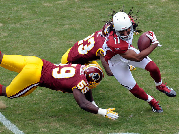 Larry Fitzgerald avoids a tackle  