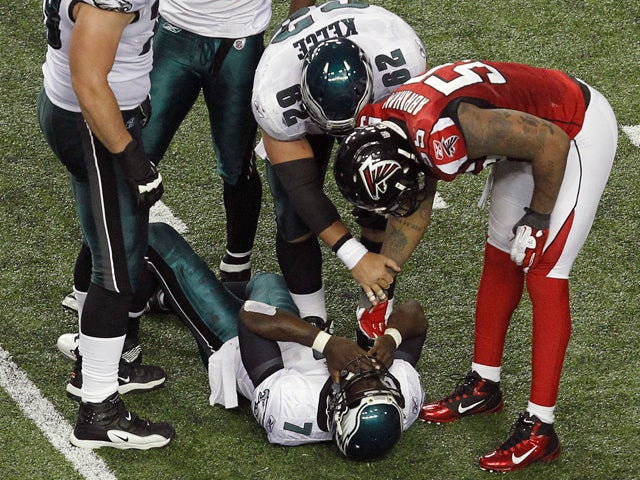 John Abraham stands over injured Michael Vick 