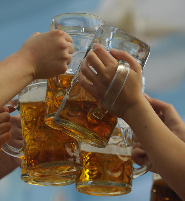 Visitors toast with beer mugs 