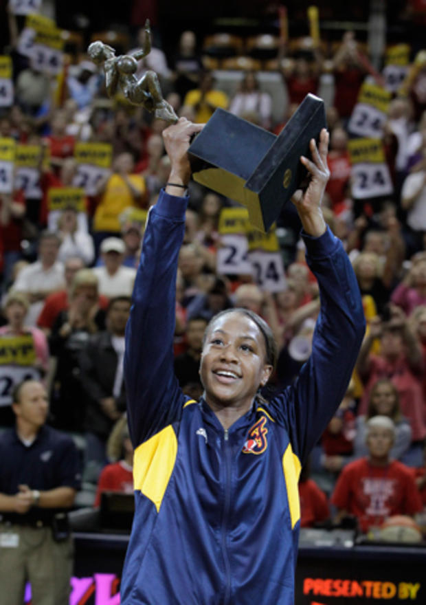 Tamika Catchings holds the WNBA's most valuable player trophy 