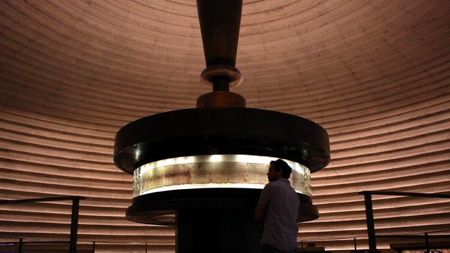 At the Shrine of the Book at the Israel Museum Sept. 26, 2011, in Jerusalem, a man looks at the Dead Sea Scrolls found in Qumaran caves in the Judean Desert that date back to 120 B.C. The scrolls contain some of the oldest-known surviving biblical texts. 