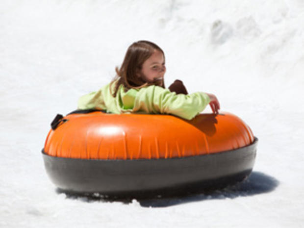 12/23/11 - A Guide to Snow Tubing in the Twin Cities Area – girl in orange tube 