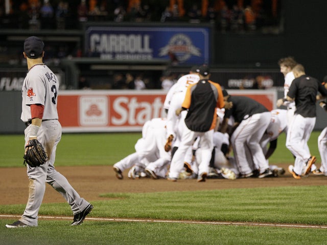 Mike Aviles  looks back at members of the Baltimore Orioles as they celebrate 