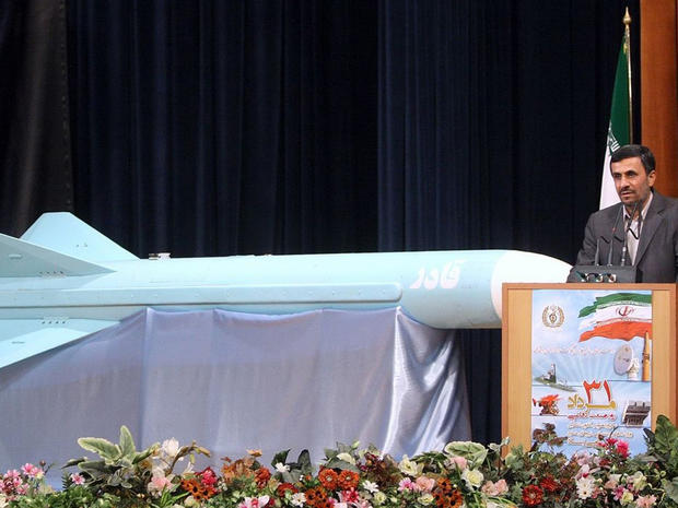 Mahmoud Ahmadinejad delivers a speech next to a Ghader missile 