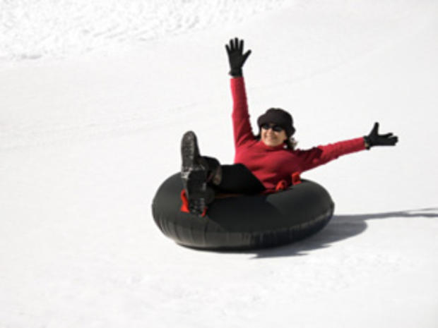 12/23/11 - A Guide to Snow Tubing in the Twin Cities Area –woman in black tube 