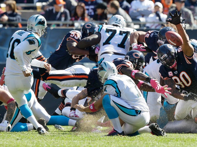 Julius Peppers reaches in to block a field goal 