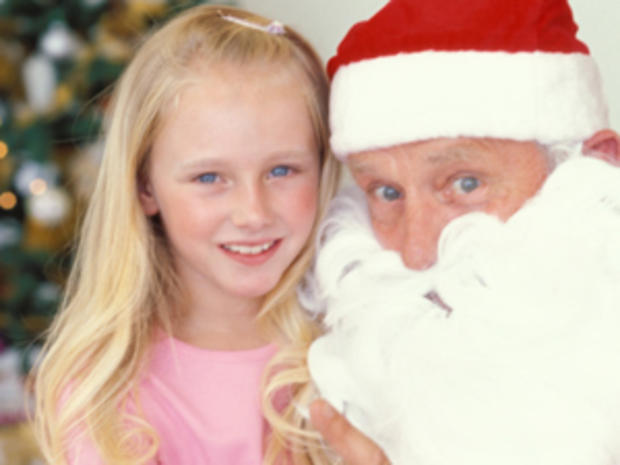 12/9/11 – Unique Holiday Happenings for Families – Girl in pink with Santa 