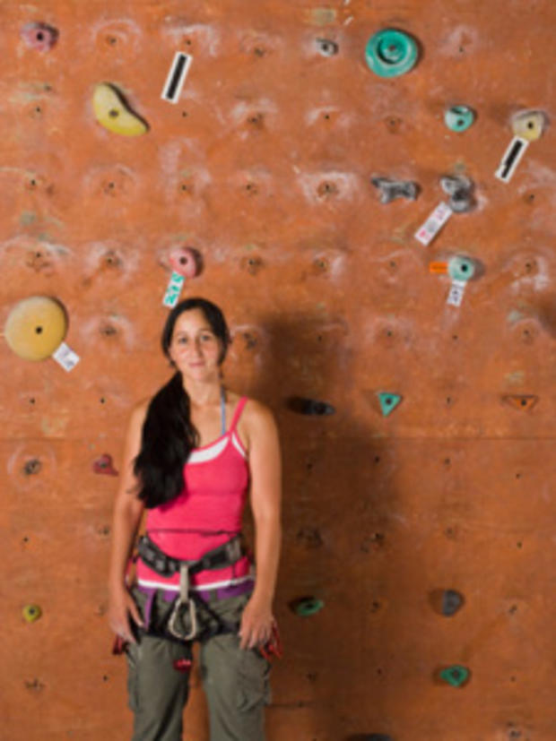 12/31/11- Best Ways to Stay Fit During Winter- woman in pink by climbing wall 