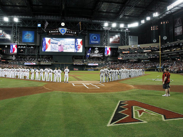 Diamondbacks and Brewers stand for the national anthem  