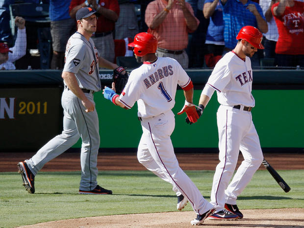 Elvis Andrus is congratulated by Michael Young scoring 