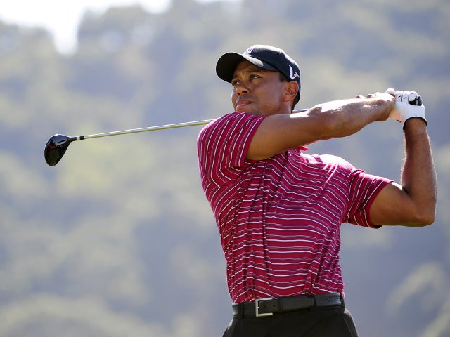 Tiger Woods makes a tee shot 