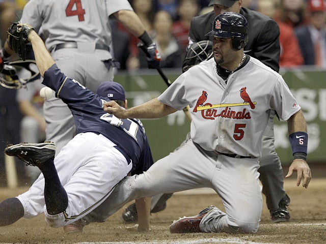 Albert Pujols slides safely past Marco Estrada 