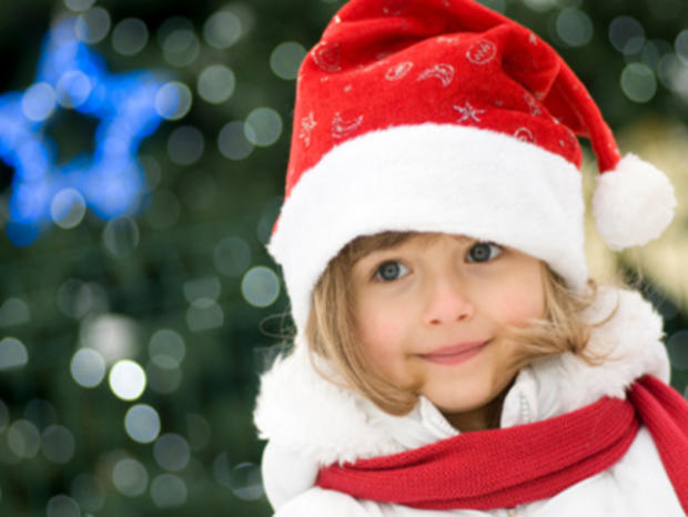 12/17/11- Travel &amp; Outdoors- Best Christmas Town Celebrations- little girl in Santa hat 