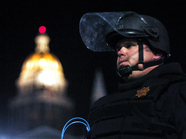 A Colorado State Patrol officer stands guard at the Occupy Denver protest in front of the Colorado state Capitol Oct. 14, 2011. Dozens of police in riot gear pushed Wall Street protesters into retreat outside the Capitol, and the protesters retreated with 