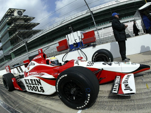 Dan Wheldon sits in his car 