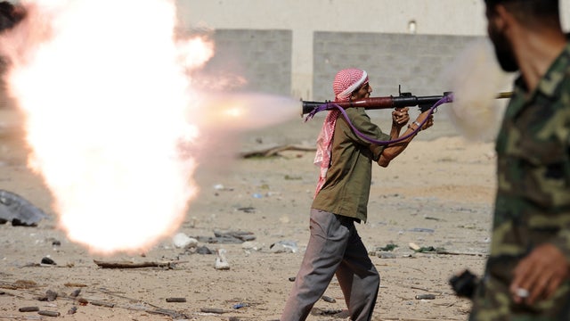 A Libyan Transitional National Council fighter fires a rocket-propelled grenade during a street battle in Sirte, Libya, Oct. 18, 2011. Fierce street fighting erupted in Muammar Qaddafi's sole remaining bastion as streets reverberated with the sound of hea 