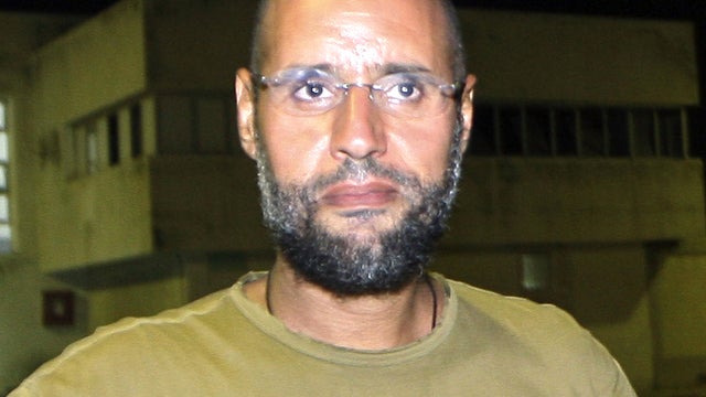 Saif al-Islam Qaddafi, son of ousted Libyan leader Muammar Qaddafi, appears in front of journalists at his father's residential complex in the Libyan capital of Tripoli Aug. 23, 2011. 