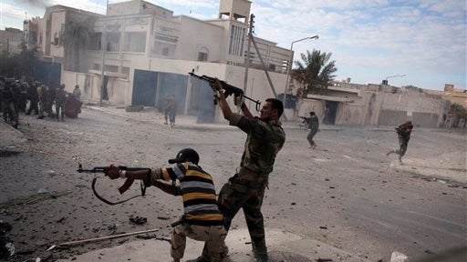 Libyan rebel fighters firing machine guns toward loyalist positions in Sirte on Wednesday. Reporters there say it fell on Thursday. 
