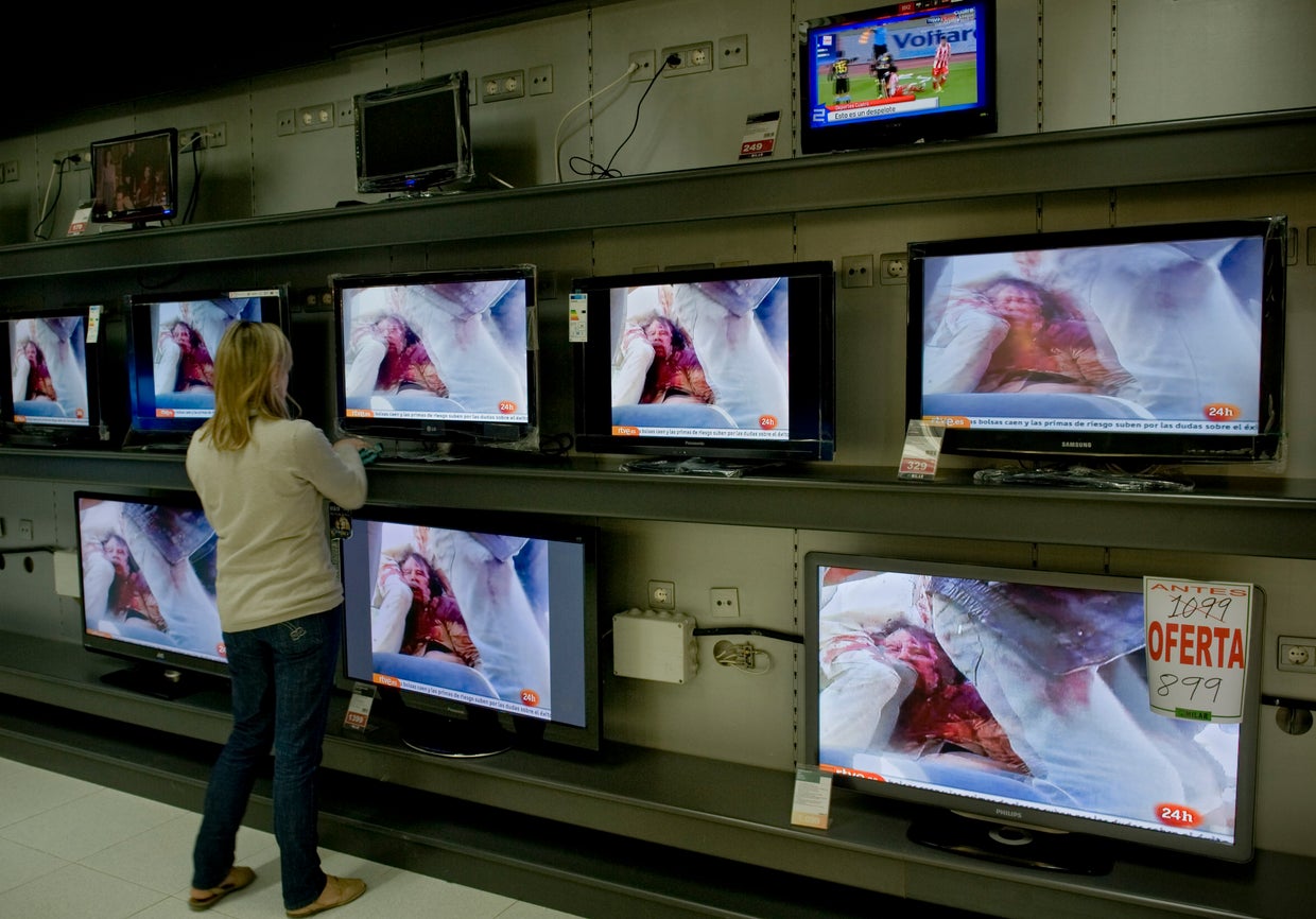A woman cleans her shop 